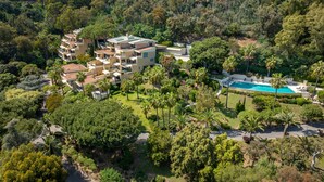 An aerial view of a modern resort with multiple buildings, a swimming pool, and lush greenery. - 223 Le Gla Euls in Golfe Juan (Vallauris)