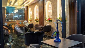 A modern interior with a seating area, a bar, and a decorative ceiling. - Histavera Hotel (Istanbul)