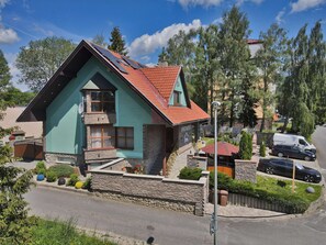 A two-story house with a sloped roof, a balcony, and a stone facade. -     Modern Apartment in High Tatras, Near Štrbské Pleso, AC, WiFi (Tatranská Strba)