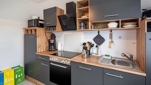 A modern kitchen with a built-in oven, microwave, and a sink.
