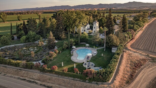 A large estate with a swimming pool, landscaped garden, and a tower house. - Inn at Park Winters (Winters)