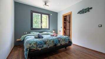 A bedroom with a bed, a window, a closet, and a ceiling fan.