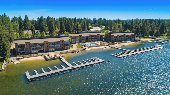 A waterfront hotel with multiple buildings, a dock, and a swimming pool. - Relax in this spacious 3-bedroom condo in McCall's Crystal Beach, ideal for families. (McCall)