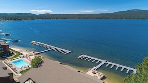 A waterfront property with a swimming pool, dock, and clear views of the lake and surrounding forest. - Relax in this spacious 3-bedroom condo in McCall's Crystal Beach, ideal for families. (McCall)
