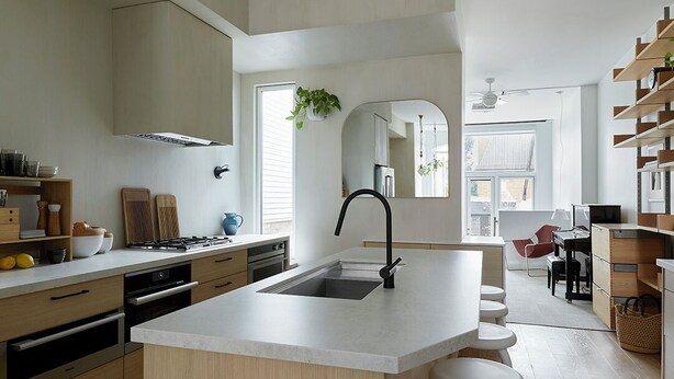 A modern kitchen with a central island, a built-in stove, and a large window providing natural light. - Downtown Toronto row house. Close to Ossington, Trinity Bellwood & BMO field. (Toronto)
