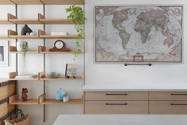 A room with wooden shelves, a world map, and a desk.