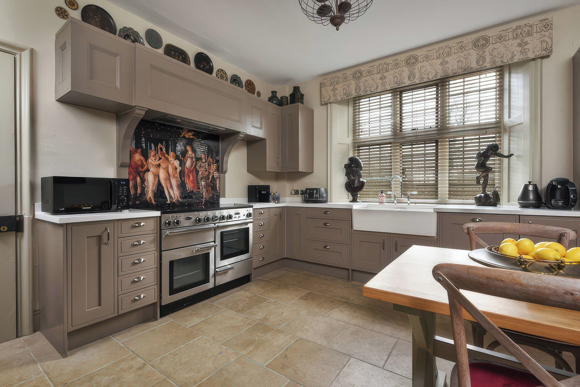 A kitchen with a stove, oven, microwave, and a dining area with a table and chairs.
