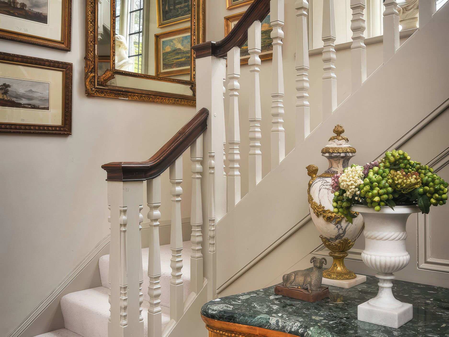 A staircase with white balusters and a marble top.