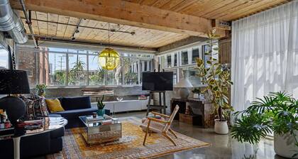 Sun-drenched, chef's kitchen, and beautifully collected, Arts District loft