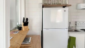 A kitchen with a white refrigerator, wooden countertop, and a sink. - Retro Retreat - Riverfront Access - St. Clair River (st clair)
