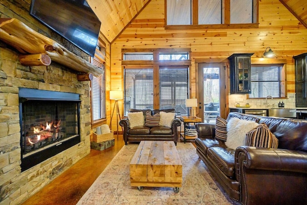 Cozy living room with fireplace & leather seating