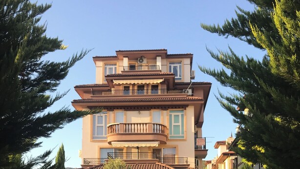 A multi-story building with a central balcony, surrounded by trees and a stone staircase leading up to the entrance. - Two-room apartment 350 m from the beach, good infrastructure, quiet location (Sweti Wlas)