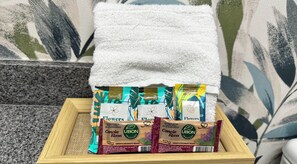 Ein hölzernes Tablett mit drei Packungen Ubon Tradicao Canela Rosa Seife auf einem strukturierten grauen Teppich.