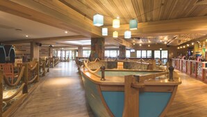 A wooden interior with a pool table, seating areas, and a bar. - Caravan Sleeps 5 - Decking, Parking, Pet Friendly (Blackpool)