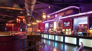 A bar area with a counter, seating, and a television screen. - Caravan Sleeps 5 - Decking, Parking, Pet Friendly (Blackpool)