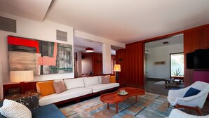 A modern living room with a sofa, armchairs, a coffee table, and a large abstract painting on the wall. - Carthage Villa 3BR Luxury Pool Garden (Carthage)