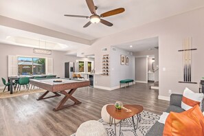 A spacious living area with a pool table, a ceiling fan, and a dining area with chairs and a table. - Scottsdale 4 Bdrm Retreat, Pool, Spa, Prime Location! (Scottsdale)