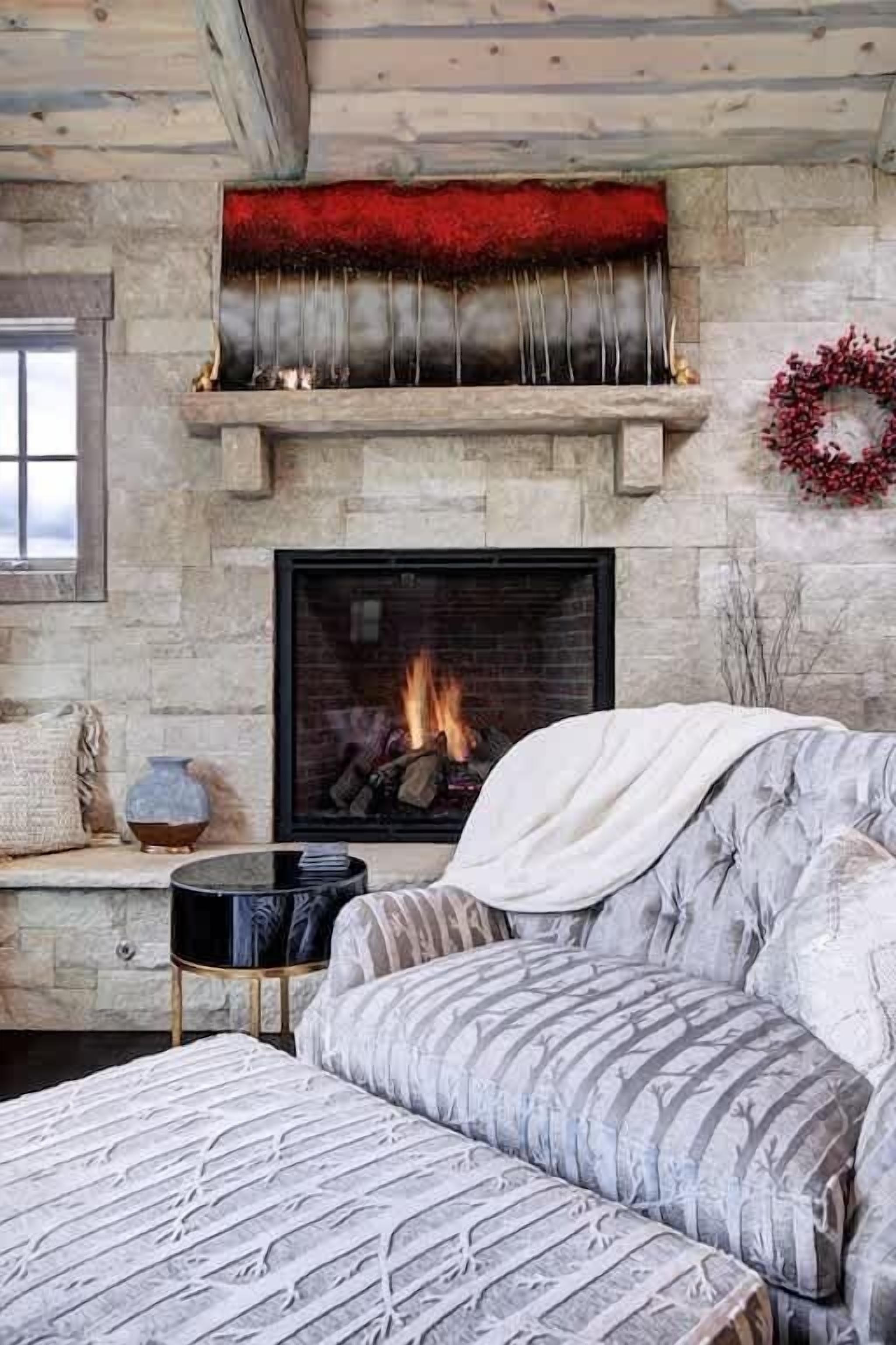 A cozy living room with a fireplace, a sofa, and a coffee table.