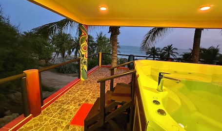 Outdoor spa tub. Two-story, two-bedroom oceanfront suite with private jacuzzis and full kitchen.