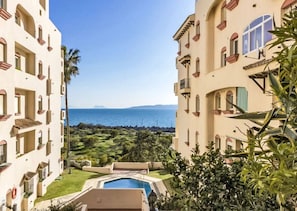 A hotel with a pool, a view of the sea, and a well-maintained garden. - Mbb53 - Beachfront Penthouse With Sea Views (Estepona)
