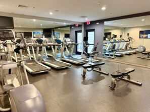 A gym with treadmills, ellipticals, and weight machines. - Accessible 1BR Suite | Pool & Daily Breakfast (Oconomowoc)