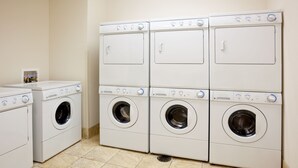 A laundry room with six stacked washing machines and a dryer. - Accessible 1BR Suite | Pool & Daily Breakfast (Oconomowoc)