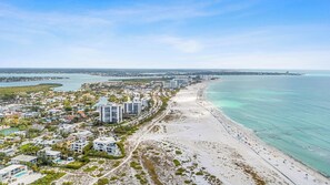 A coastal cityscape with a beach, high-rise buildings, and a marina. - St. Armands Circle Luxe 5BR Home with Private Pool (Sarasota)
