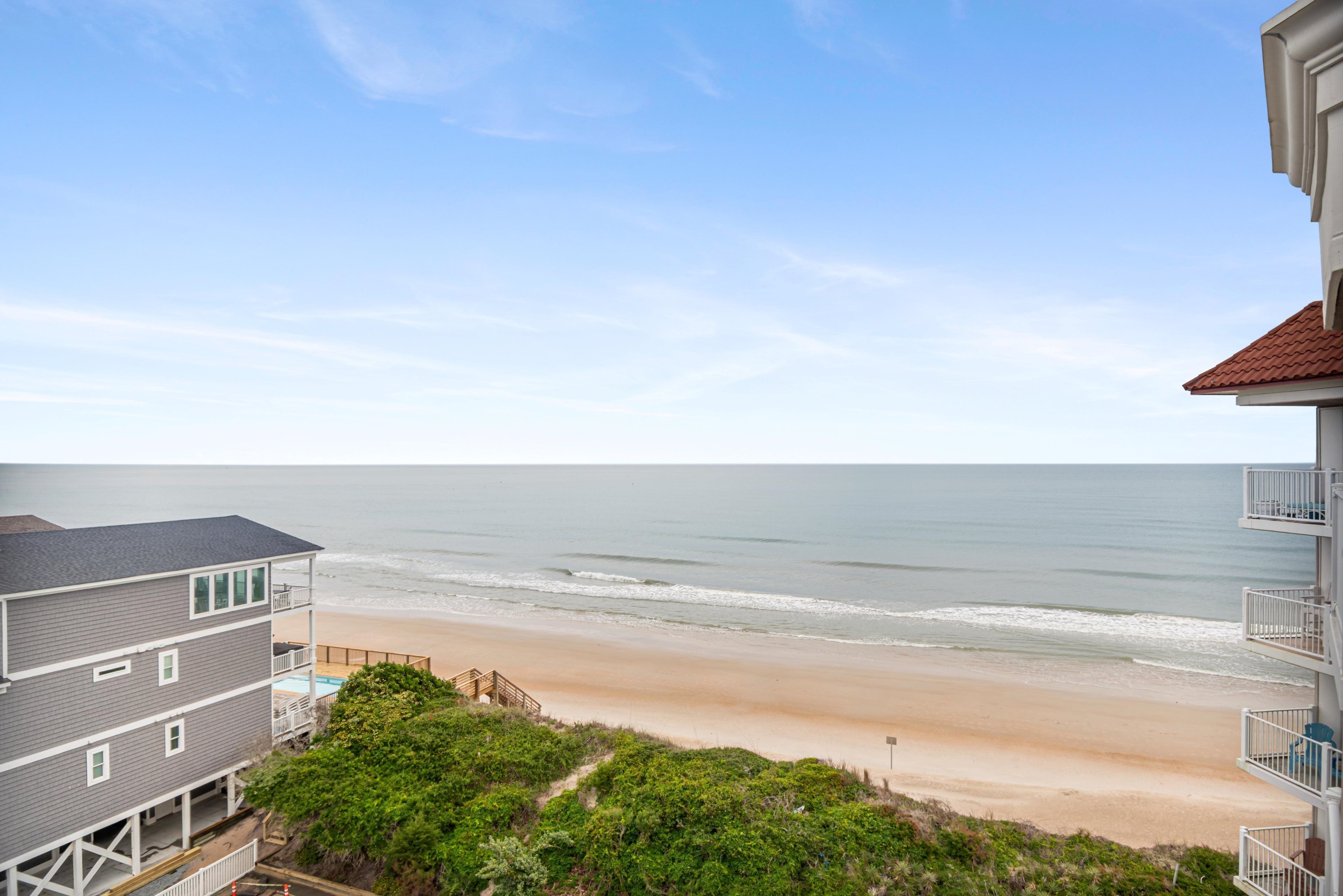 A beachfront hotel with a pool, a beach view, and a balcony.