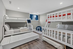 A children's room with bunk beds, a window with curtains, and a small blue chair. - NEW*Lakefront-Private Chef-Beach + Kayaks-WI Dells (New Lisbon)