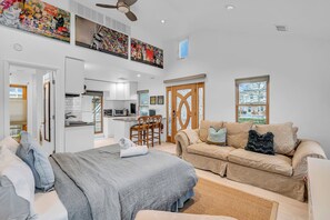 A modern hotel room with a bed, a sofa, a dining area, and a kitchen. - Cozy 1-bedroom studio 4 blocks from the beach and 7 blocks from Cookman (Asbury Park)
