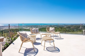 A terrace with outdoor seating and a panoramic view of the coastline. - Villa California I - Seven Bedroom Villa, Sleeps 14 (Califòrnia)