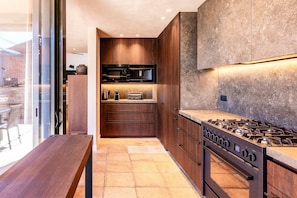 A modern kitchen with a built-in stove, microwave, and oven. - Villa Dumas I - Five Bedroom Villa, Sleeps 12 (Sitges)
