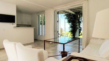 Bungalow, animali ammessi, vista mare | Area soggiorno | TV a schermo piatto 26 pollici con canali via cavo, libri