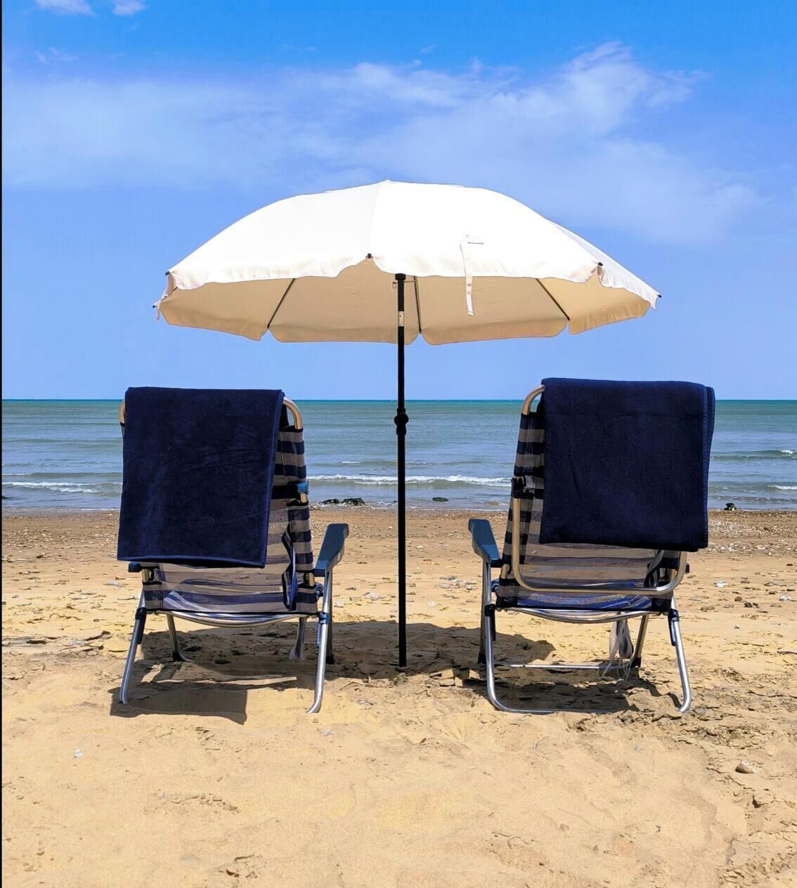 On the beach, sun-loungers, beach umbrellas, beach towels