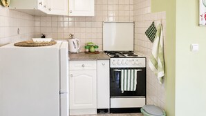 A kitchen with a refrigerator, stove, oven, and various kitchen items. - Lovely apartment in Kukljica with WiFi (Kukljica)
