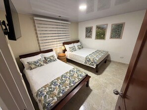 A hotel room with two beds, a large window with blinds, a ceiling light, and three framed pictures on the wall. - Casa Danta privileged location (Salento)
