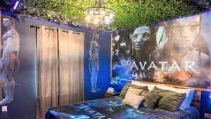 A bedroom with a bed, curtains, a wall mural, and a chandelier. - 5BR Home with Pool and Game Room Disney (Davenport)