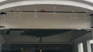A multi-story building with a curved balcony, large glass windows, and star-shaped decorations. - height909hostal (Juayua)
