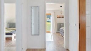 A hallway with a bed, radiator, and a view of the outdoors. - Dog-Friendly Holiday Apartment with 2 Balconies and Wi-Fi (Bräunlingen)
