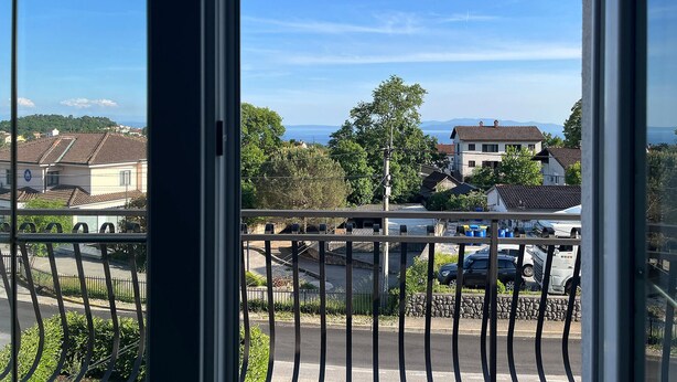 Un quartier résidentiel avec des maisons, un ciel dégagé et une vue sur la mer.