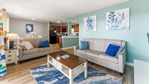 A living room with two sofas, a coffee table, and artwork on the walls. - MB Ocean Spa 526-Ocean view, Great Amenities (Myrtle Beach)