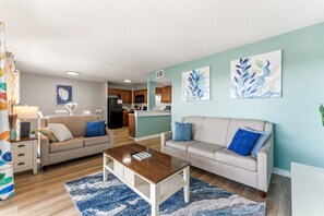 A living room with two sofas, a coffee table, and artwork on the walls. - MB Ocean Spa 526-Ocean view, Great Amenities (Myrtle Beach)