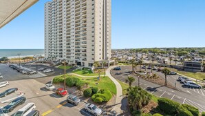 A high-rise hotel with a parking lot, a landscaped area, and a view of the beach. - MB Ocean Spa 526-Ocean view, Great Amenities (Myrtle Beach)
