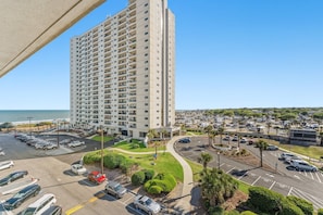A high-rise hotel with a parking lot, a landscaped area, and a view of the beach. - MB Ocean Spa 526-Ocean view, Great Amenities (Myrtle Beach)