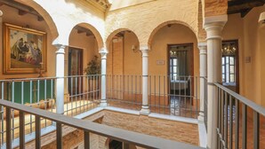A spacious interior with a balcony, arched ceilings, and a sign reading 'CADIZ'. - Casa Rural Andalucía Aracena by Ruralidays (Huelva)