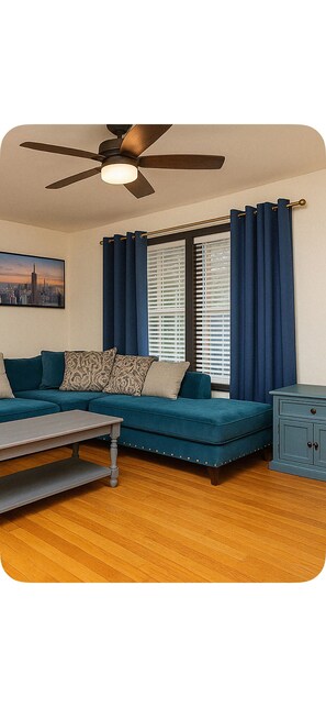 A living room with a sofa, a coffee table, a ceiling fan, and a cabinet. - 5BR Retreat with Theater and Game Room Near Downtown + POOL (San Antonio)