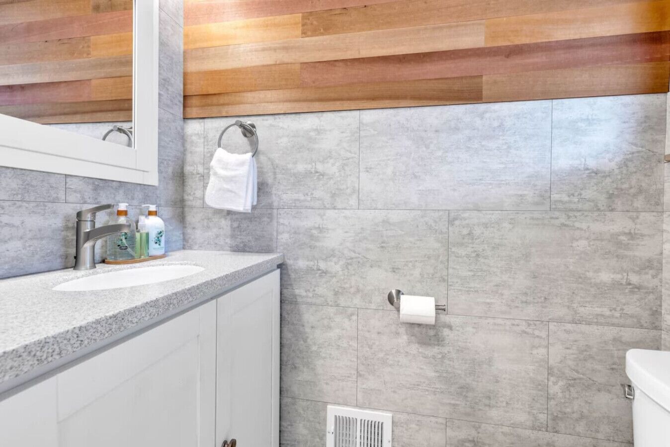 Smaller bathroom with toilet and sink — added convenience for guests.