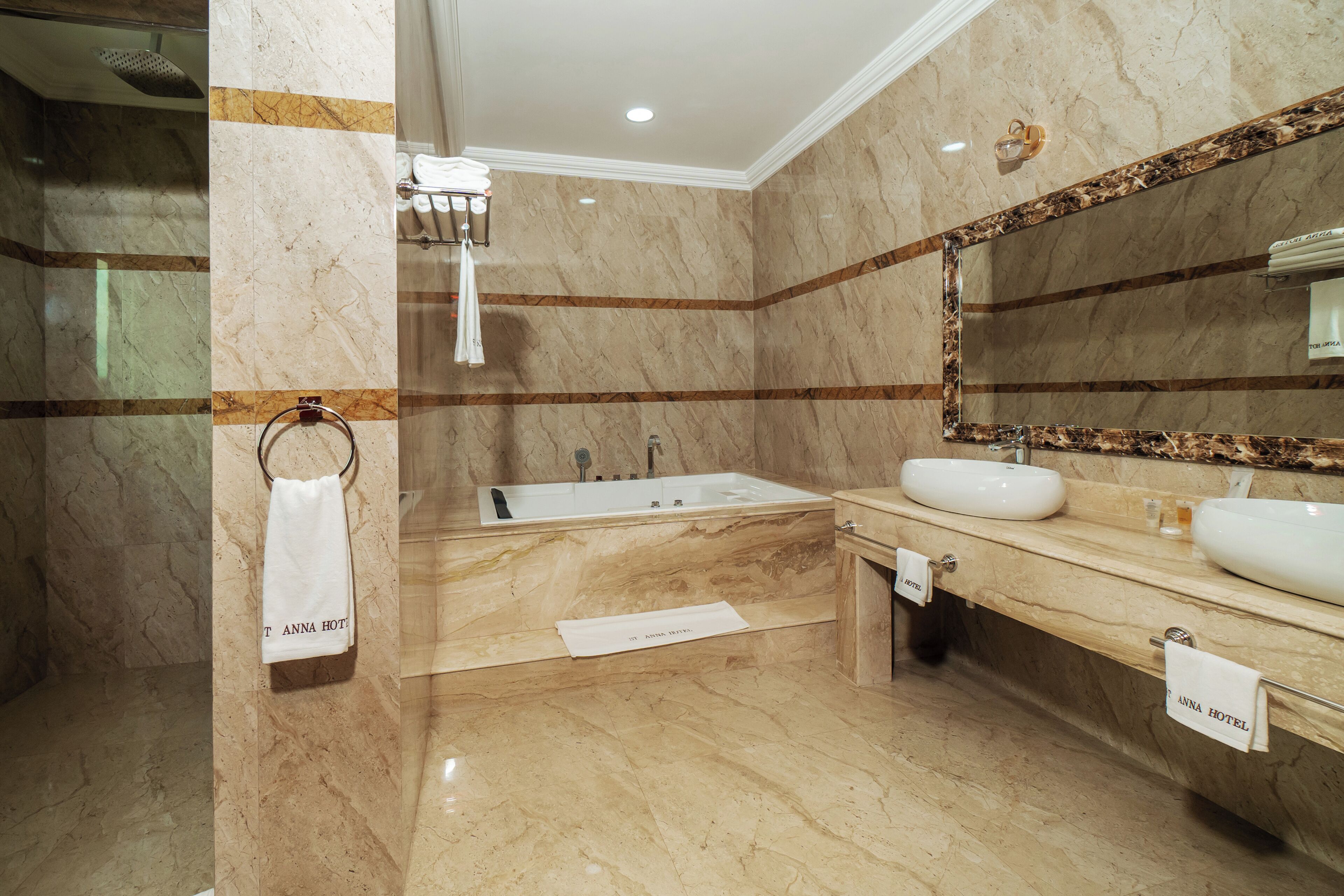 A bathroom with a bathtub, a sink, and a mirror.
