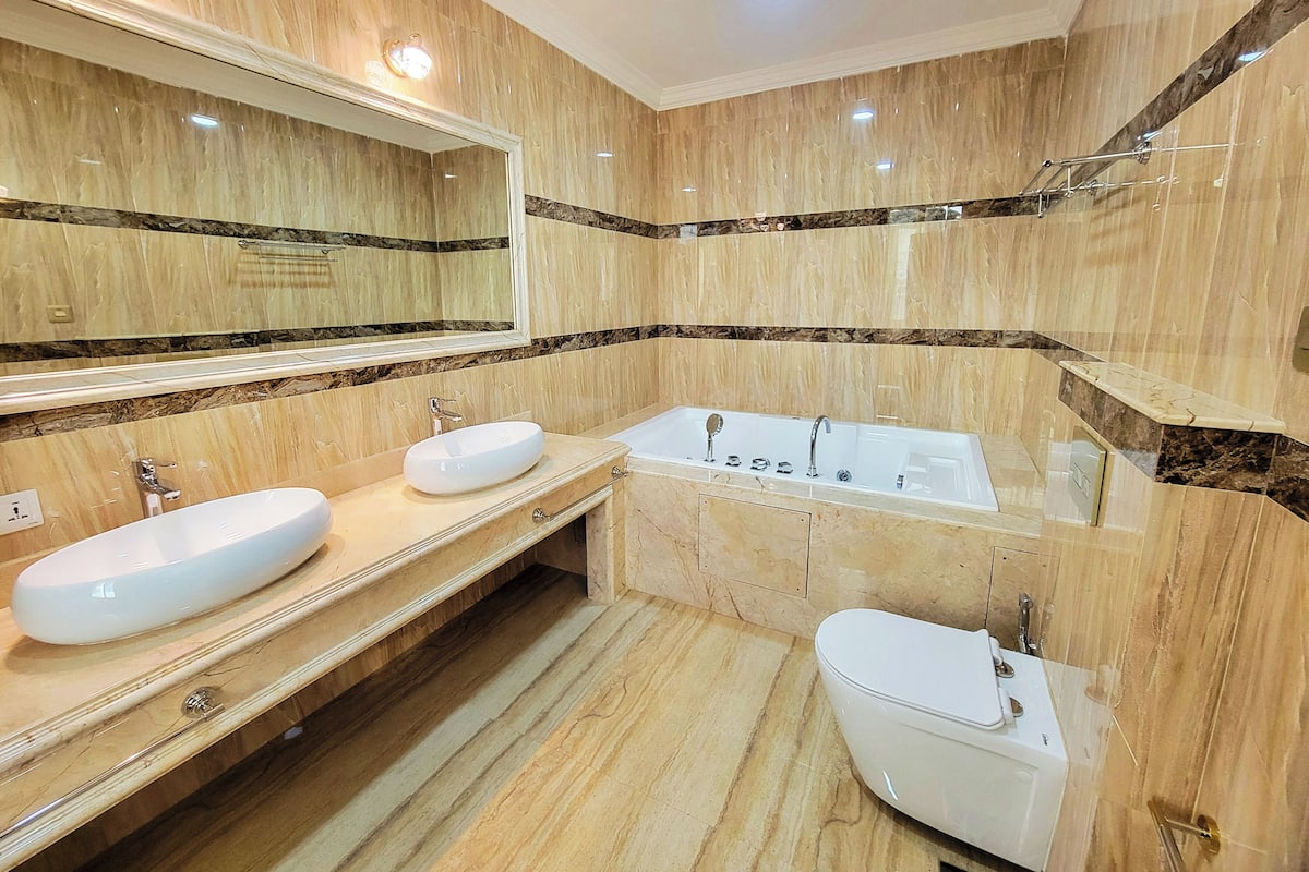 Separate tub and shower, hair dryer, slippers, towels