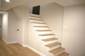 A staircase with wooden steps and white walls. - Bright Modern Walkout Basement Suite 8ft Ceilings (Mississauga)